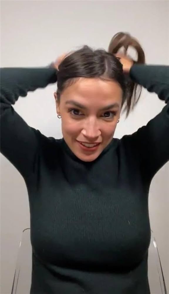 AOC putting her hair up in a dark top